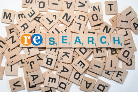 text Research spelled out with Scrabble letters in background
